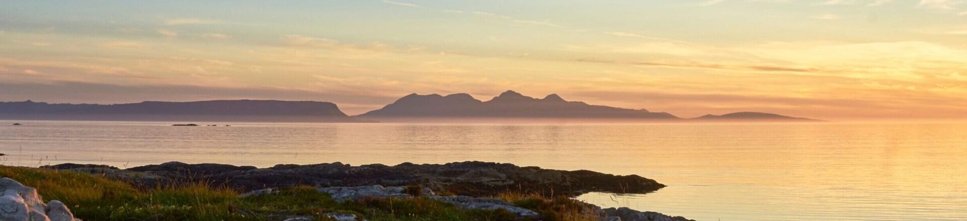 https://www.hebrideanadventures.co.uk/wp-content/uploads/2024/10/Sunset-Rhum-and-Eigg-scaled-e1728683420228.jpg